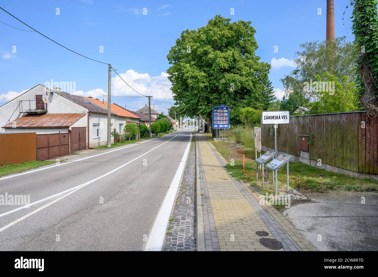 Strada d'ingresso al villaggio Zahorska Ves con grande lavagna blu Con limiti di velocità in Slovacchia (SLOVACCHIA) Foto Stock