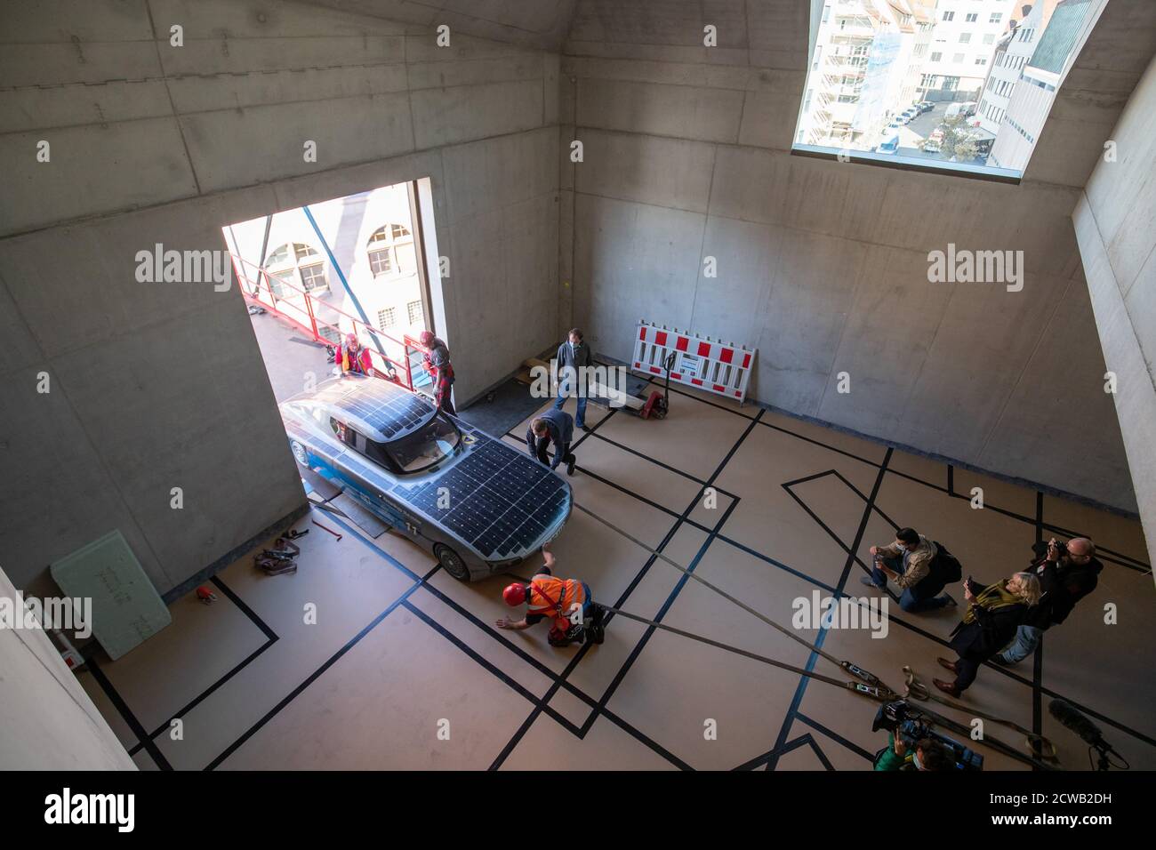 Norimberga, Germania. 29 Settembre 2020. L'auto solare blue.Cruiser è sollevato da una gru attraverso una finestra nel futuro Museo. Le prime quattro mostre si sono trasferite nello spazio espositivo della filiale del Deutsches Museum, che copre quasi 3000 metri quadrati, il 29 settembre. Una gru doveva sollevare gli oggetti attraverso una finestra nel museo perché erano troppo grandi per l'ascensore merci. Credit: Daniel Karmann/dpa/Alamy Live News Foto Stock