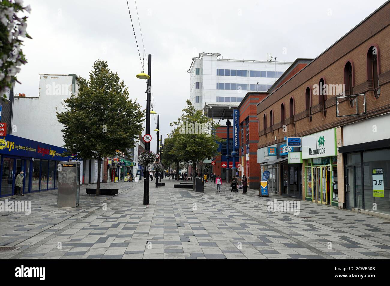 Gli acquirenti di High Street a Slough come la città del Berkshire è stato rimandato alla lista di controllo del governo a causa di un aumento dei casi di coronavirus. Foto Stock