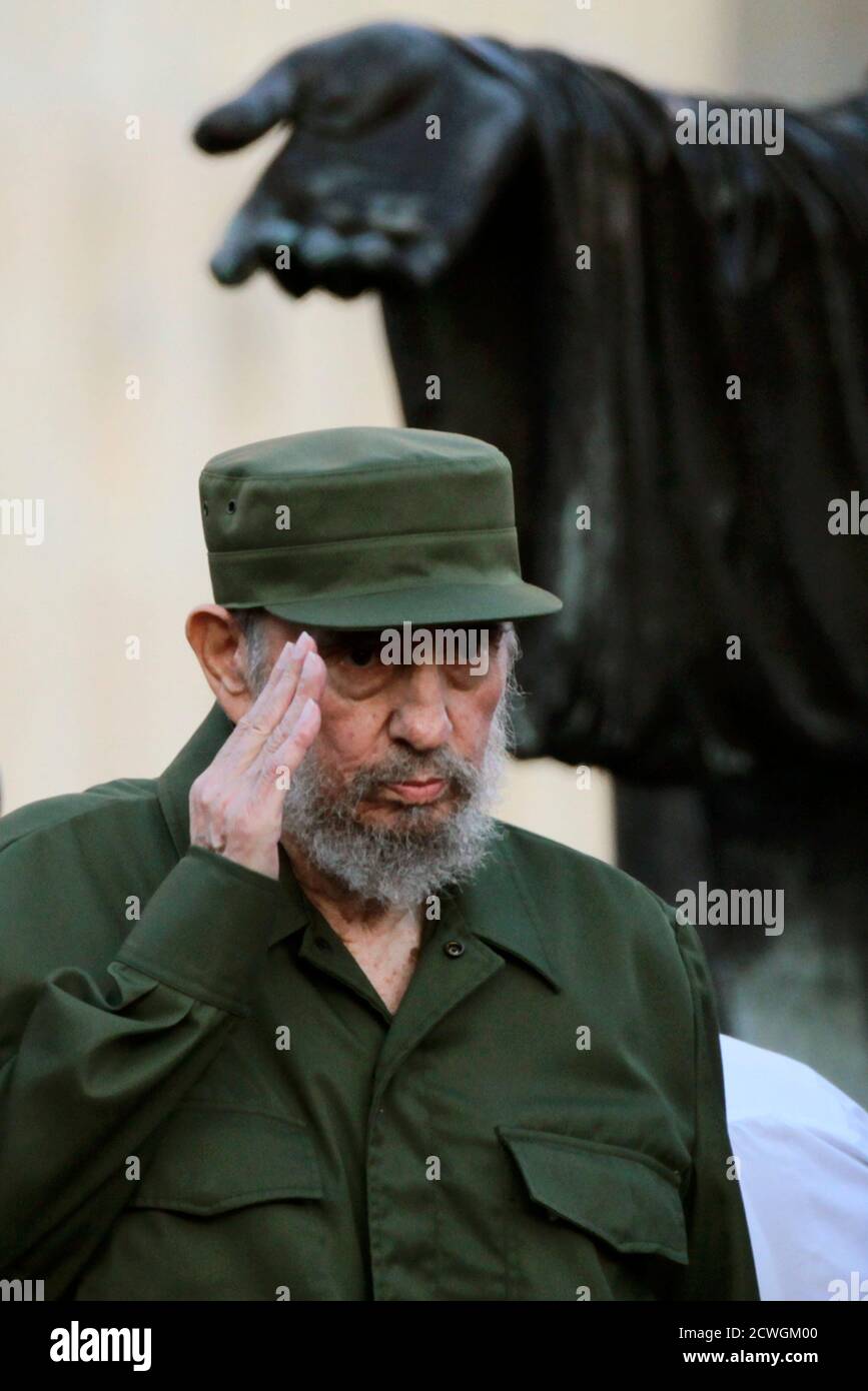 Former Cuban leader Fidel Castro salutes before a meeting with students at  Havana's University September 3, 2010. Castro, wearing his green military  cap and clothing like the comandante of old, made his