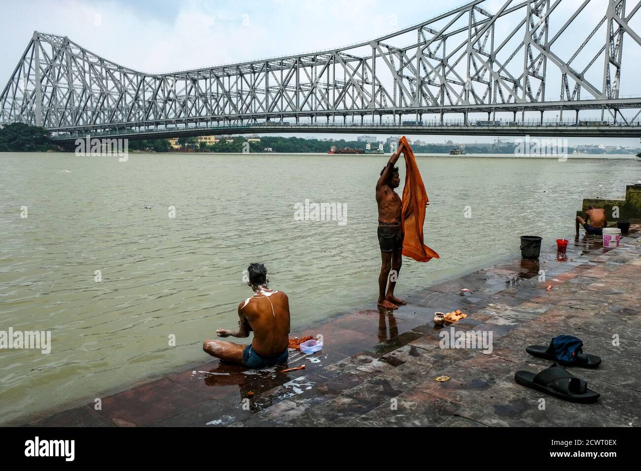 Kolkata, India - 2020 settembre: Le persone che lavano nel fiume Hooghly a Mullik Ghat vicino al ponte Howrah il 26 settembre 2020 a Kolkata, Bengala occidentale, Foto Stock