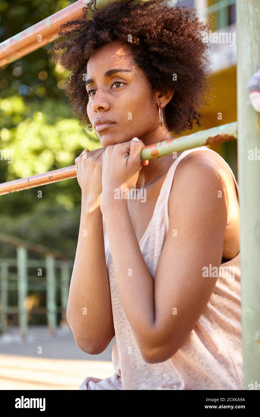 Donna giovane premurosa seduta all'aperto Foto Stock
