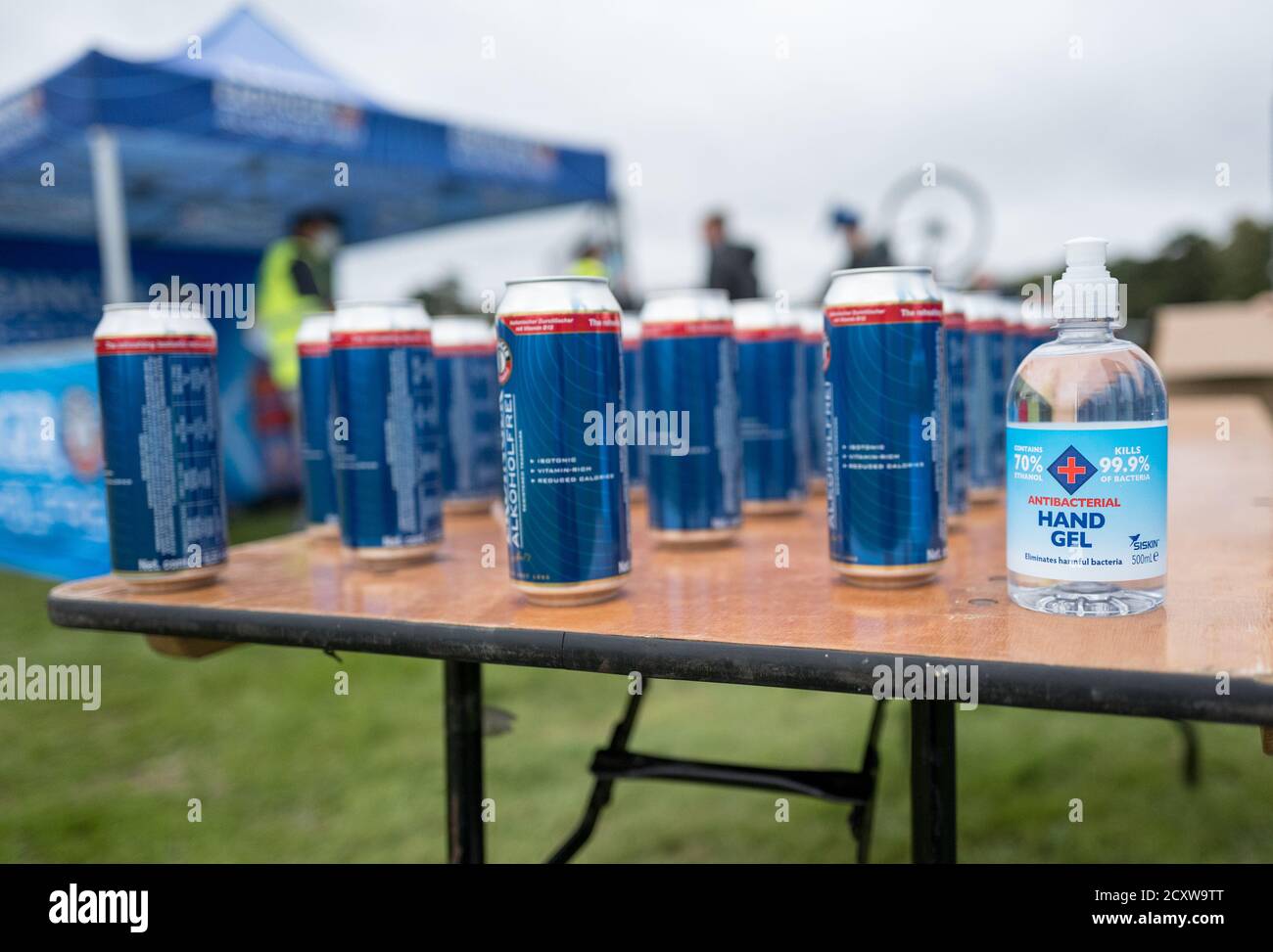 Gel antibatterico per le mani con lattine di bevande energetiche. Foto Stock