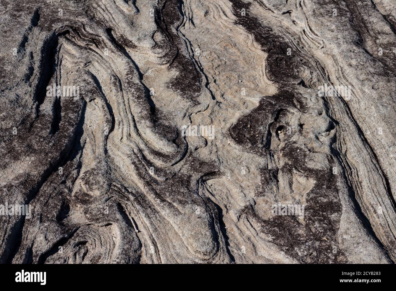 Superficie ruvida ondulata naturale in pietra arenaria ideale come sfondo Foto Stock