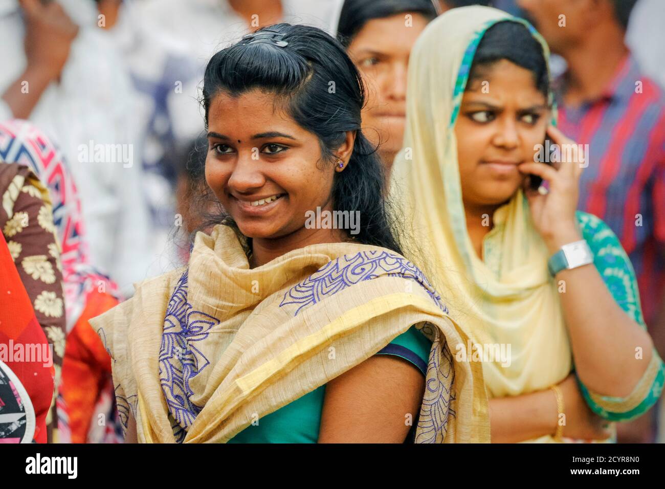 Donne in abito tradizionale alla stazione degli autobus sulla strada principale in questa città occupato tè, caffè e turismo nel distretto di Wayanad; Kalpetta, Wayanad, Kerala, India Foto Stock