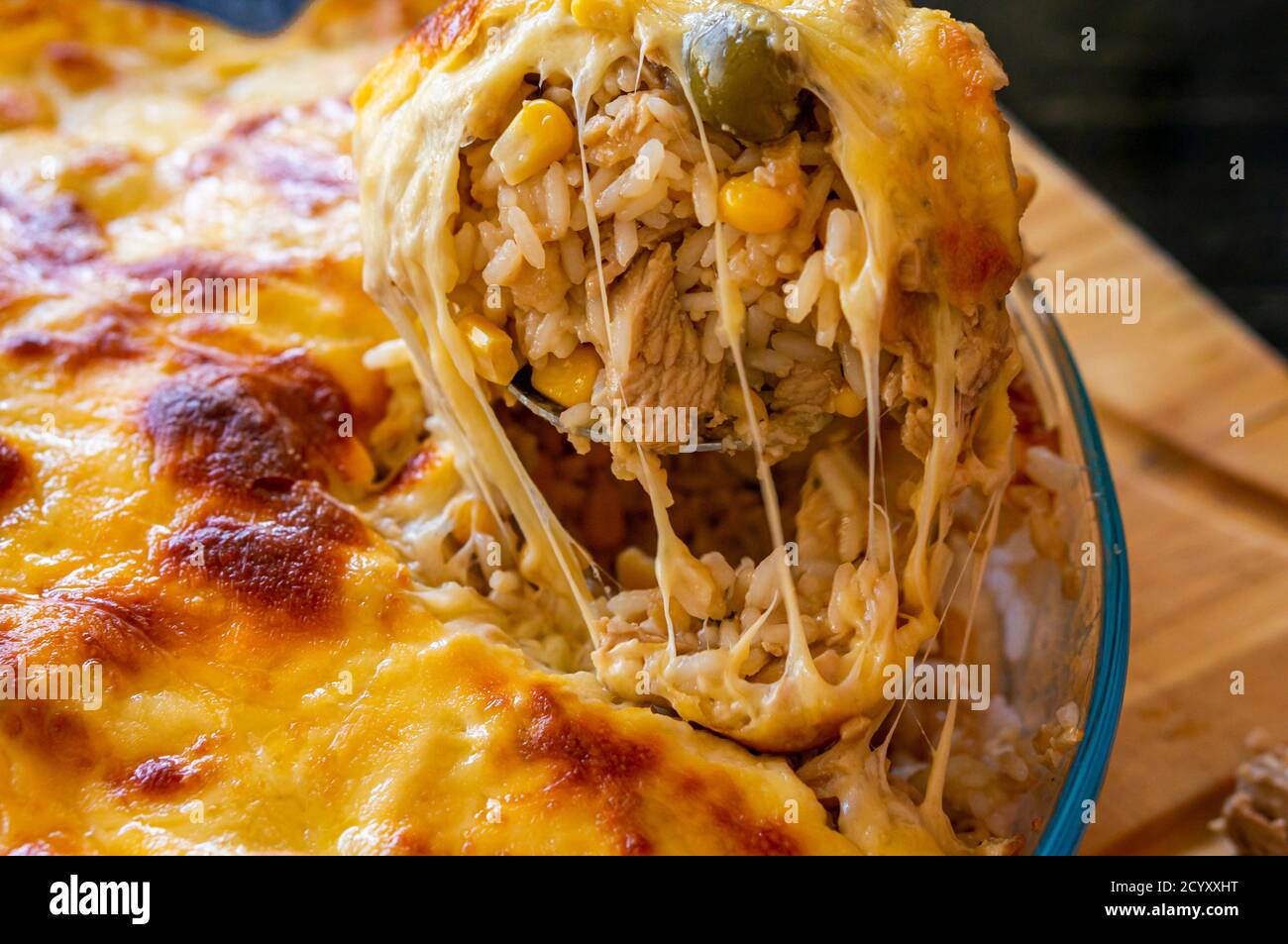 chiudere il cibo, riso mescolato con pollo tritato, mais e olive con formaggio gratinato Foto Stock