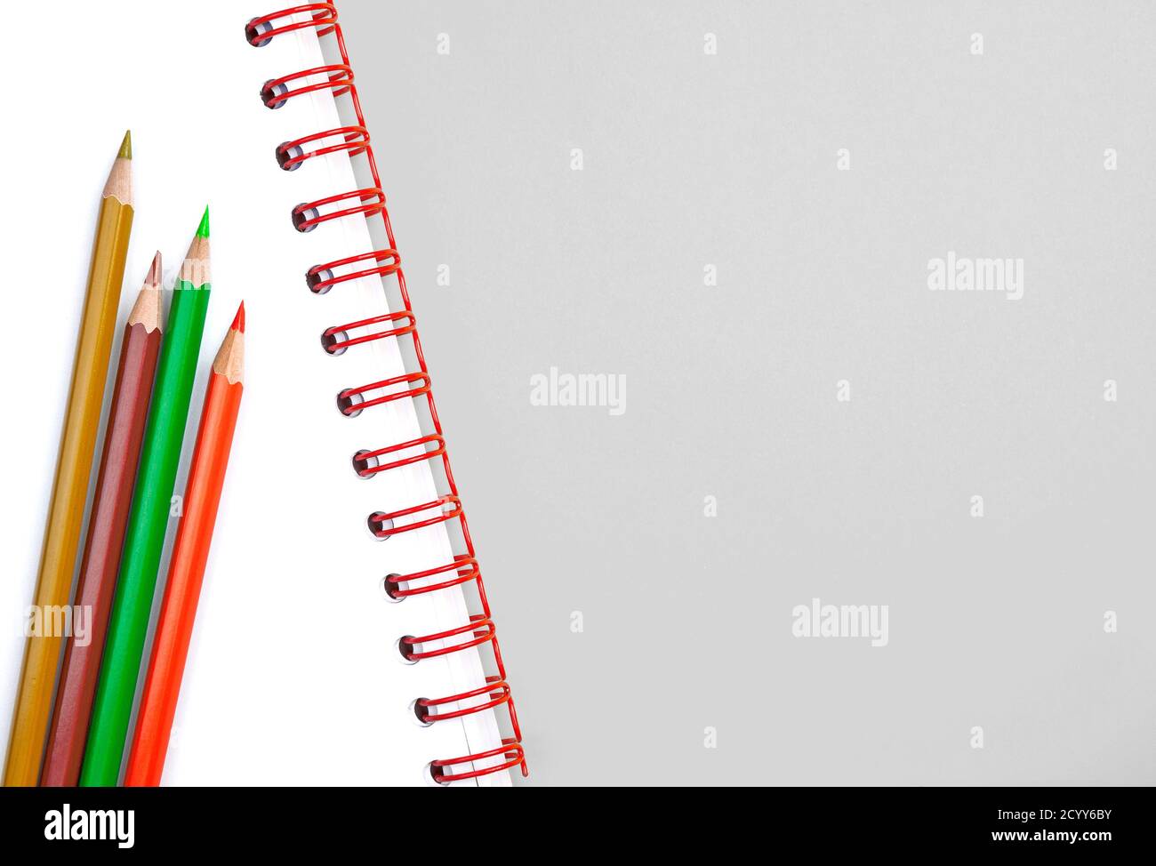 Set didattico con matite colorate su libro di testo bianco e molto di spazio di copia per aggiungere testo Foto Stock