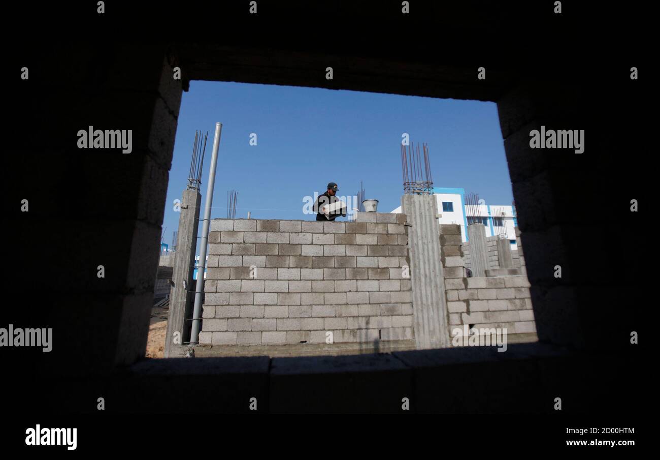 Un lavoratore palestinese lavora in un cantiere a Rafah, nella striscia di Gaza meridionale, il 2 gennaio 2013. Israele ha allentato il suo blocco di Gaza domenica, consentendo una spedizione di ghiaia per la costruzione privata nel territorio palestinese per la prima volta da quando Hamas ha preso il controllo nel 2007. REUTERS/Ibraheem Abu Mustafa (GAZA - Tags: POLITICA COSTRUZIONE DI AFFARI) Foto Stock