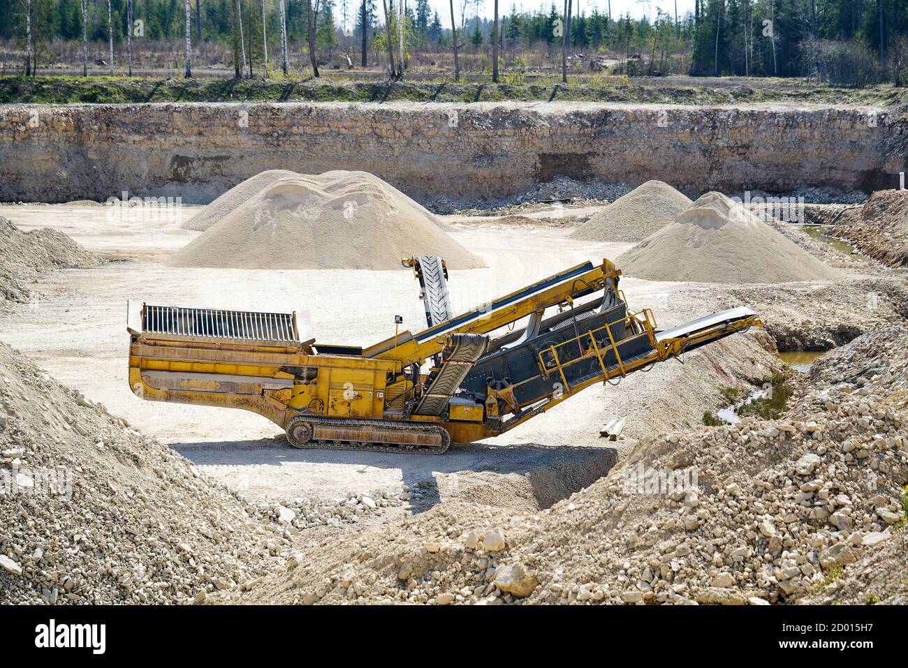 Macchina meccanica, il trasportatore a cinghia per il trasporto e per la frantumazione di pietra con sabbia. Cava di data mining per la produzione di pietrisco, sabbia e ghiaia fo Foto Stock