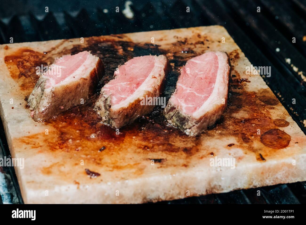 Bistecca mediamente rara alla griglia sul blocco di sale dell'Himalaya Foto Stock