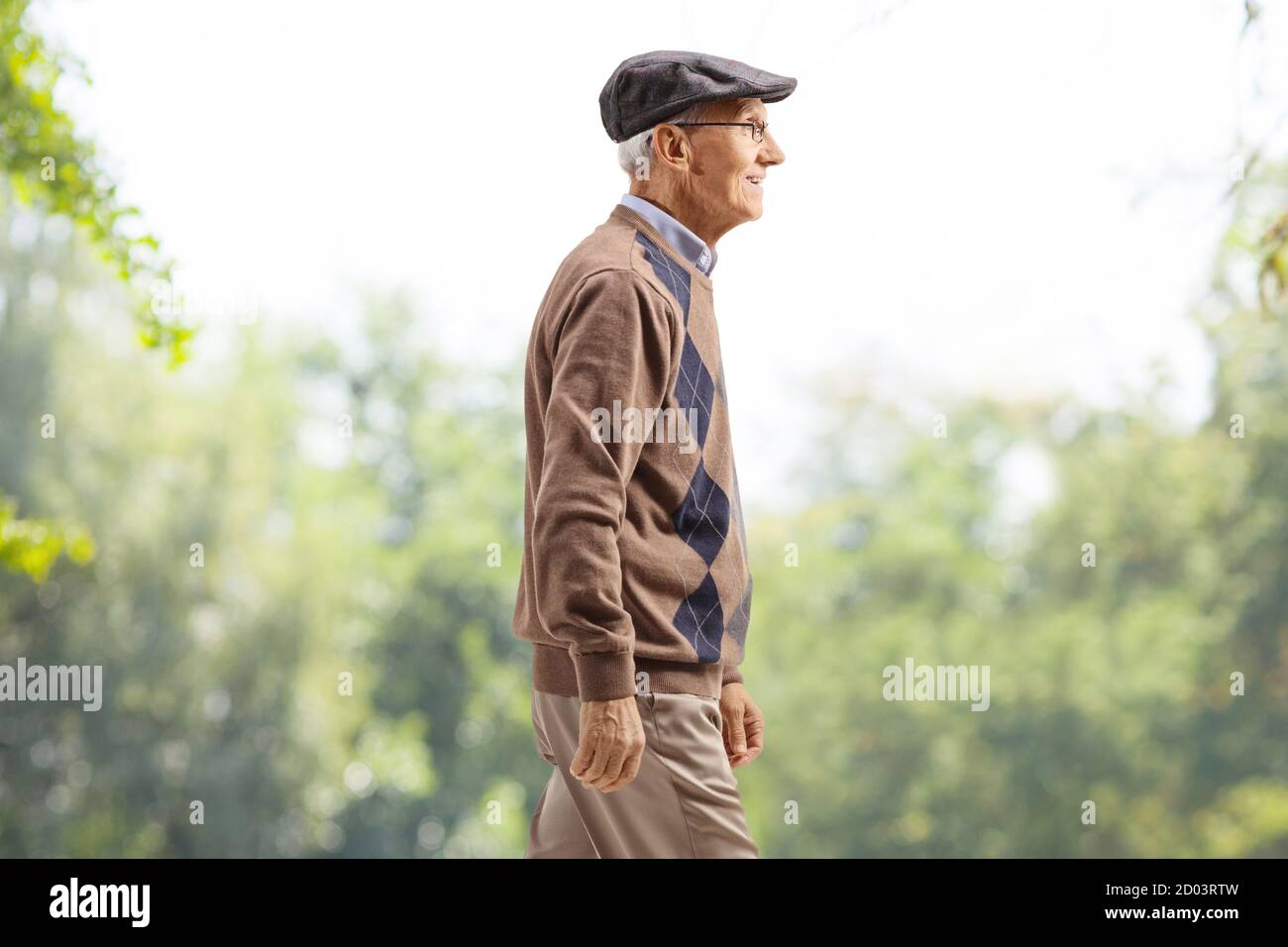 Anziano gentiluomo che cammina in un parco Foto Stock