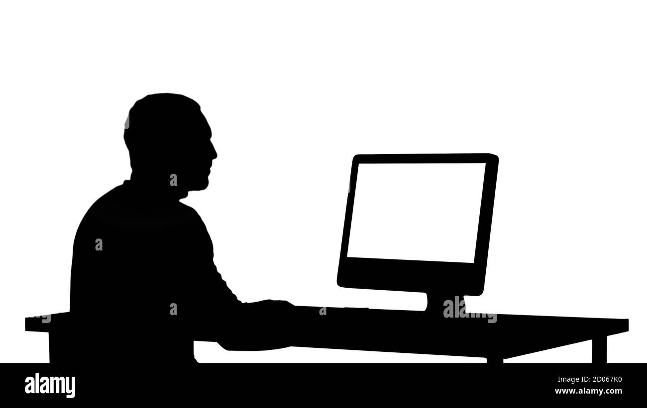 Silhouette uomo che scrive sul computer. Foto Stock