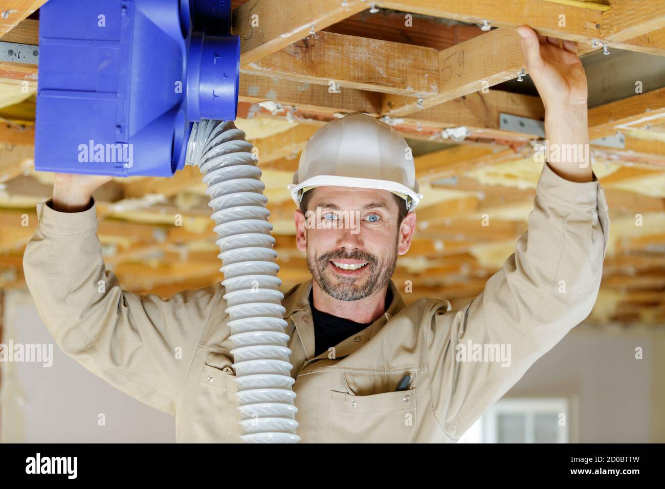 tecnico addetto alla riparazione hvac che rimuove un motorino del ventilatore dal gestore dell'aria Foto Stock