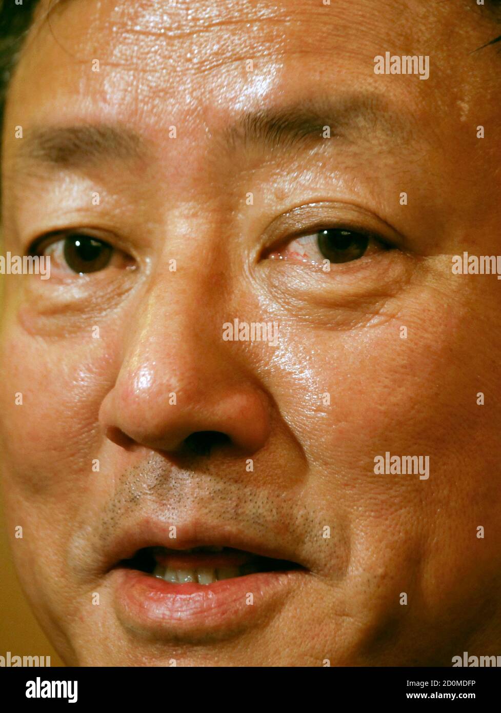 Economist Fan Gang listens to a question from a reporter in Hong Kong  September 7, 2011. China will be able to achieve a soft-landing for its  economy, influential government economist Fan, said