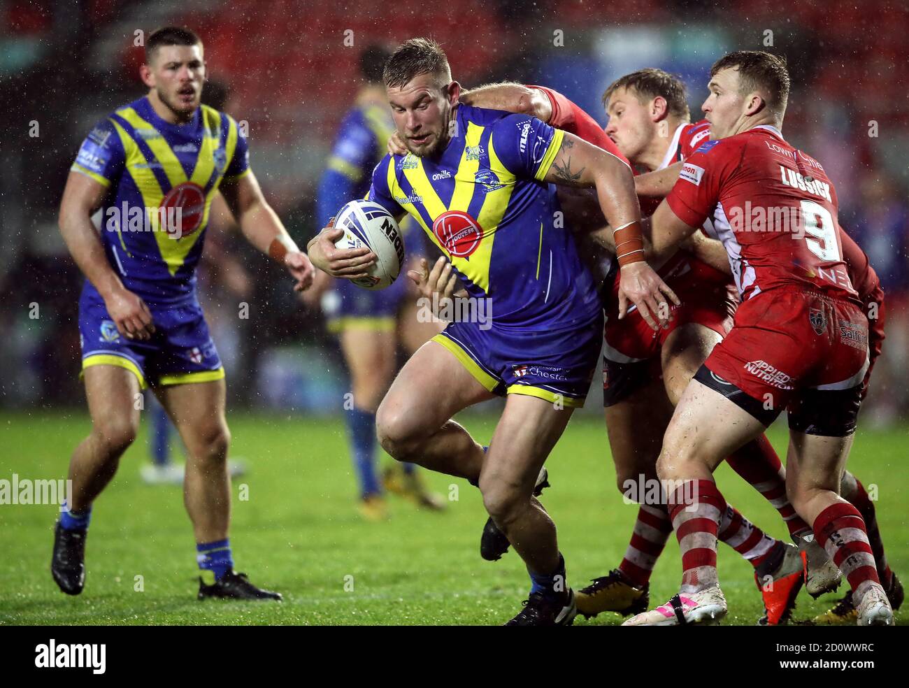 Mike Cooper dei Warrington Wolves ha affrontato Lee Mossop di Salford Red Devils e Joey Lussick durante la Coral Challenge Cup, semifinale al Totally Wicked Stadium, St Helens. Foto Stock