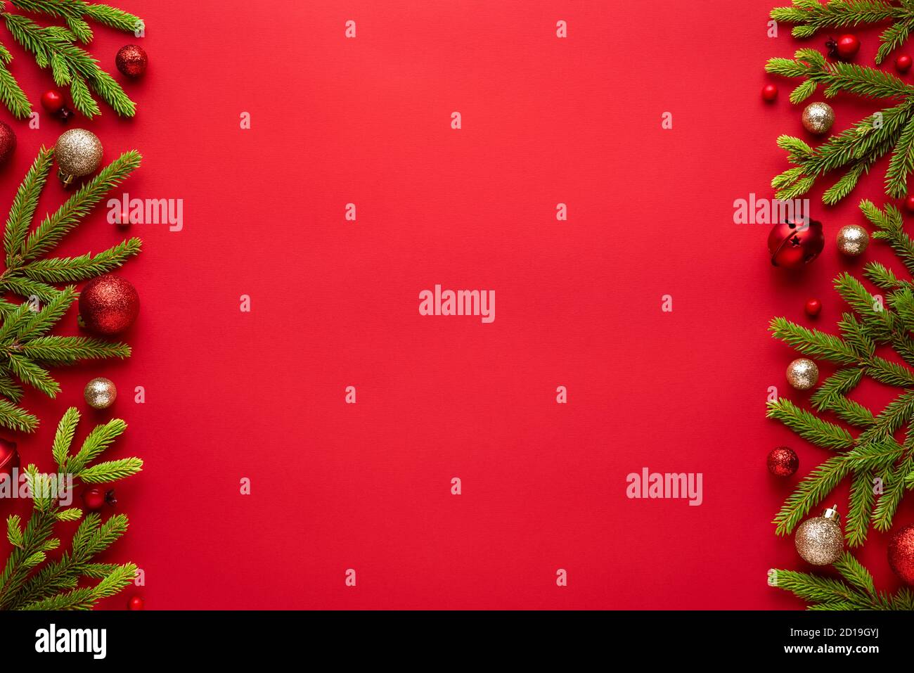 Sfondo rosso natalizio con rami e decorazioni in abete. Banner di Capodanno con spazio per la copia. Vista dall'alto, disposizione piatta Foto Stock