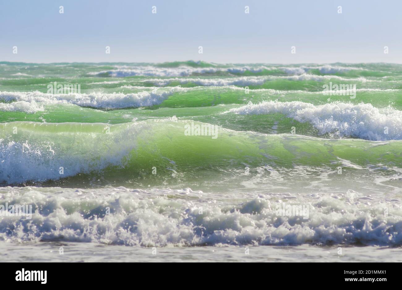 Onde da surf ruvide e increspate che si infrangono sulla riva Foto Stock