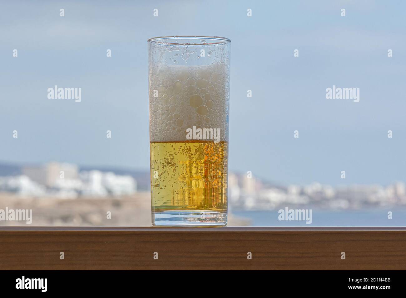bicchiere di birra schiumosa leggera in primo piano su sfondo sfocato. Foto di scorta Foto Stock