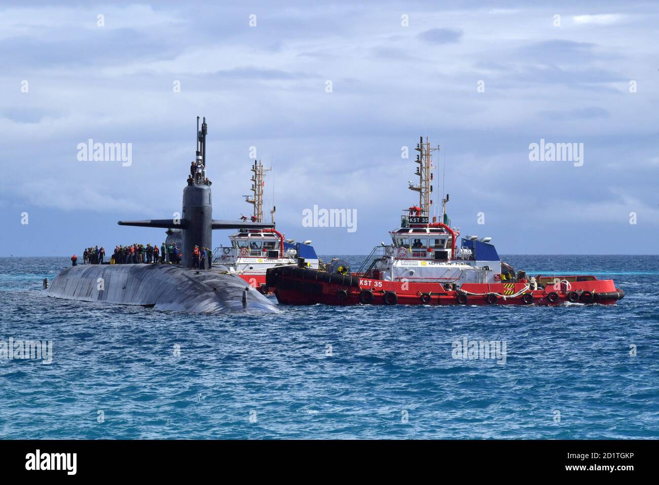 DIEGO GARCIA, territorio britannico dell'Oceano Indiano (settembre 25, 2020) – tugboats guidano il sottomarino missilistico guidato della classe Ohio USS Georgia (SSGN 729) nel porto di Diego Garcia 25 settembre 2020. La Georgia è arrivata a Diego Garcia per condurre uno swap dell'equipaggio. NSF Diego Garcia fornisce supporto logistico, di servizio, ricreativo e amministrativo agli Stati Uniti e alle forze alleate schierate in avanti nell'Oceano Indiano e nel Golfo Arabico. (STATI UNITI Navy Photo by Mass Communication Specialist Seaman apprendista Mariterese Merrique/released). Foto Stock