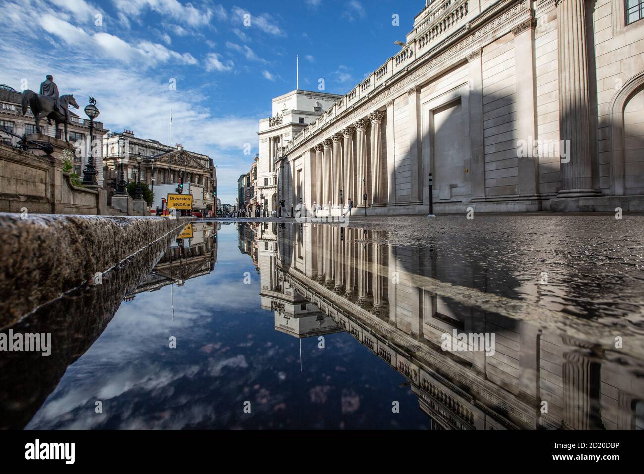 Bank of England, e Royal Exchange si sono riflesse in un pozze dopo le forti tempeste di pioggia nella City of London, Threadneedle Street, Inghilterra, Regno Unito Foto Stock