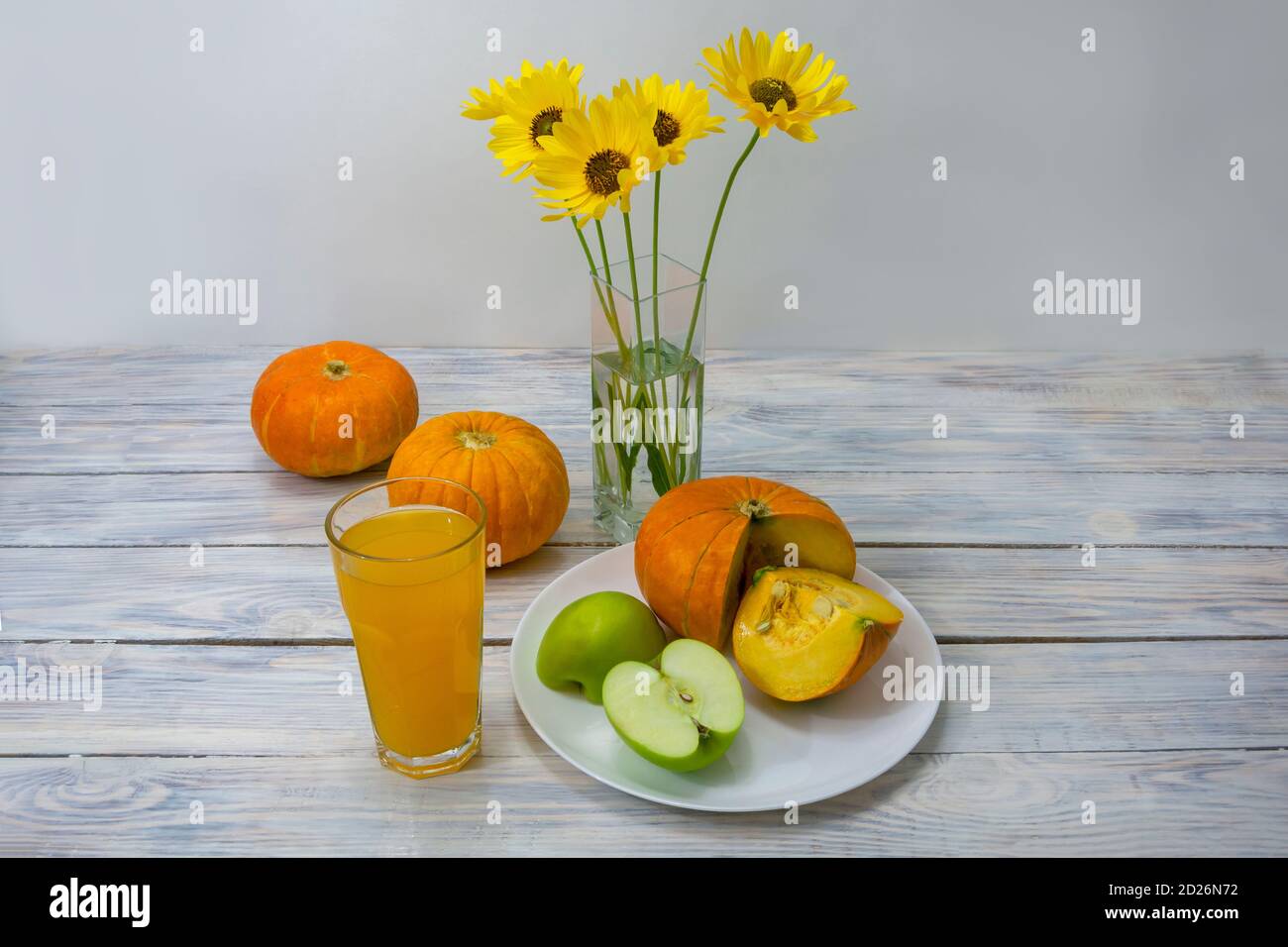 Cibo per una dieta a basso contenuto calorico. Zucca, mela verde e succo fresco su tavolo di legno. Il concetto di dieta disintossicante, perdita di peso, salute. Messa a fuoco selettiva. Foto Stock