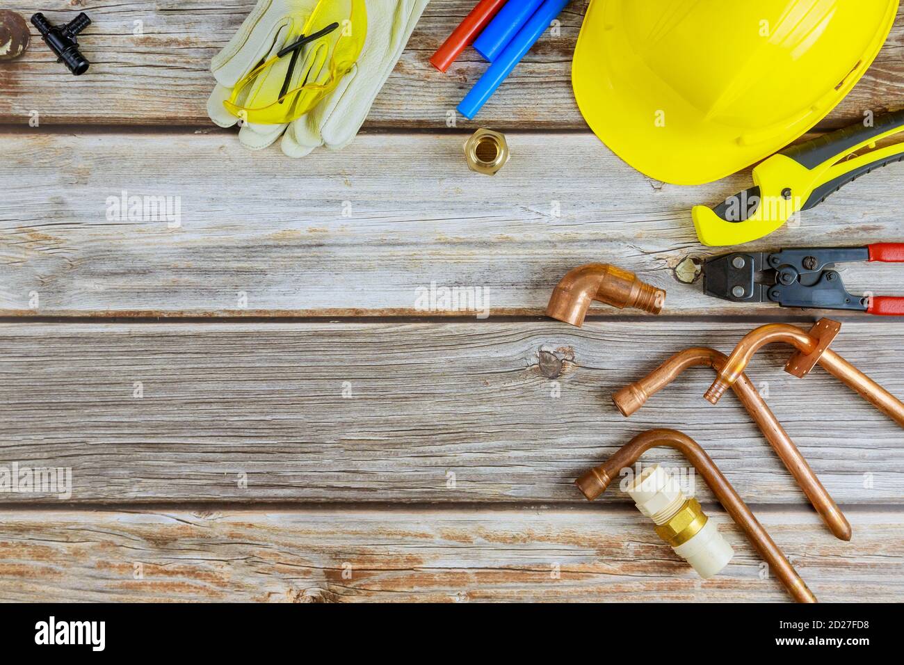 Vista dall'alto degli attrezzi idraulici sui raccordi per tubi flessibili attrezzi idraulici materiali tra cui tubo in rame, giunto a gomito, chiave per chiave per idraulico principale Foto Stock