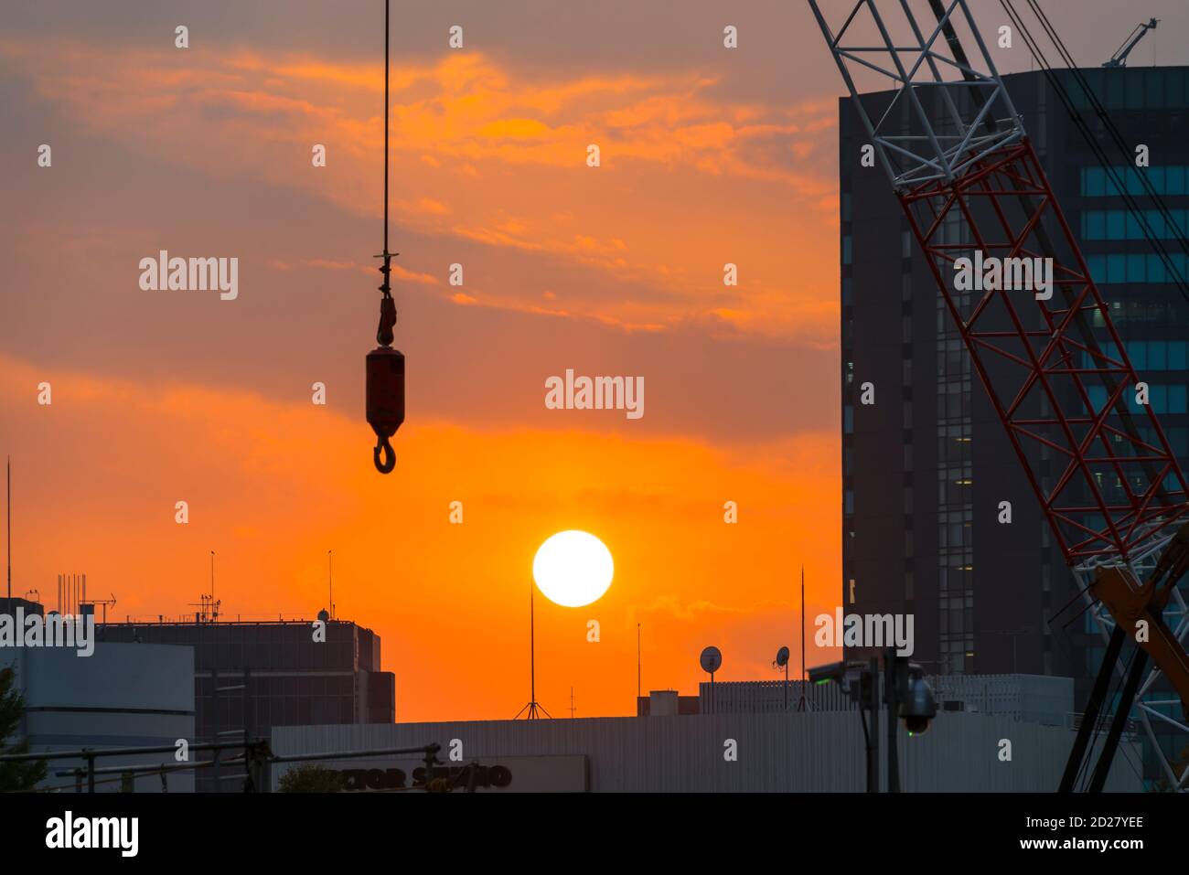 Il sole tramonta dietro il sito di costruzione del Japan National Stadium. Foto Stock