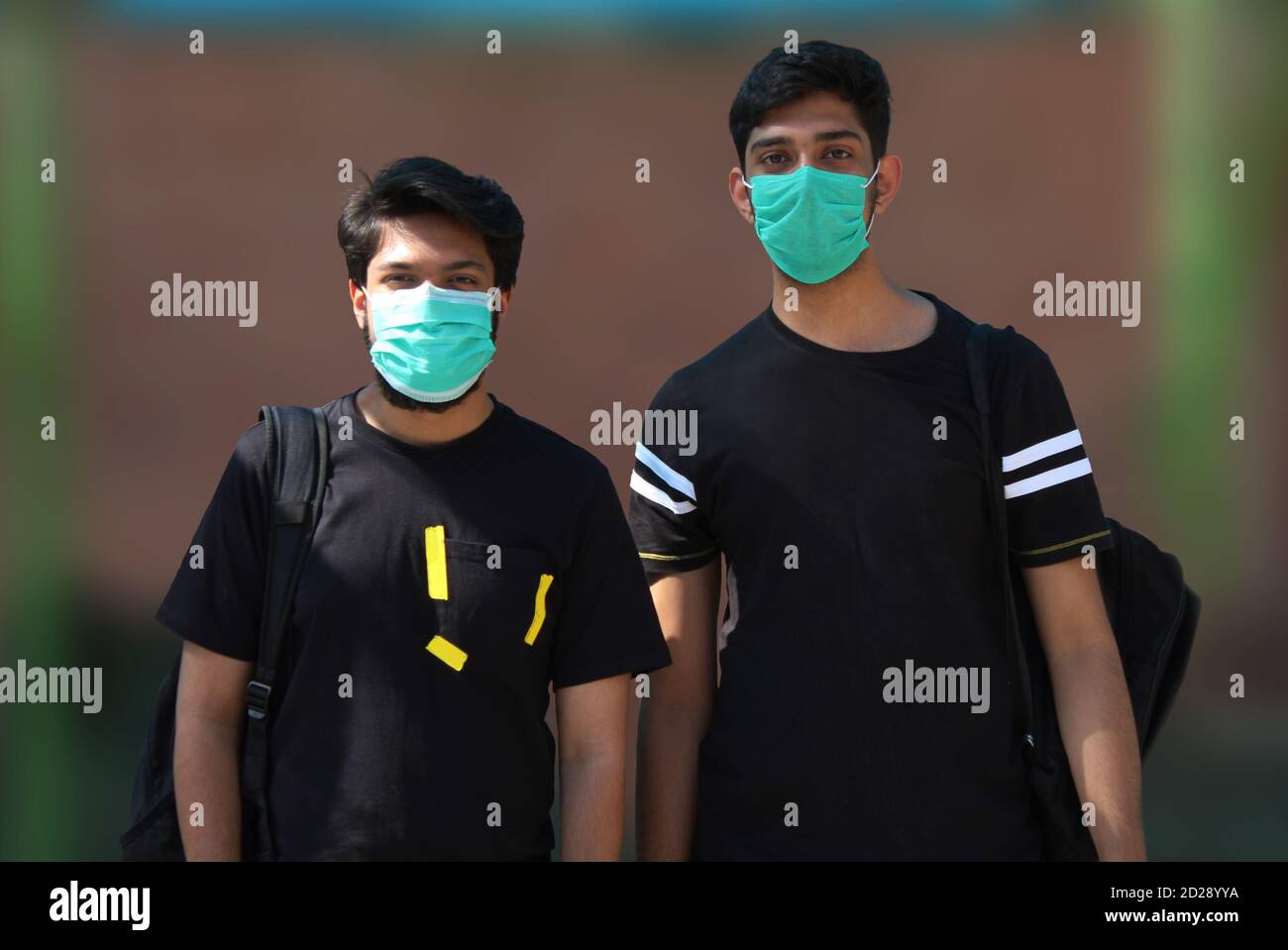 Studenti universitari che indossano maschere per il viso dopo la riapertura di scuole/college Foto Stock