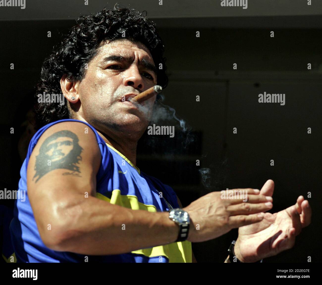 Former Argentine soccer star Diego Maradona smokes a cigar before the start  of the Argentine First Division soccer match between Boca Juniors and [San  Lorenzo de Almagro] at La Bombonera stadium in