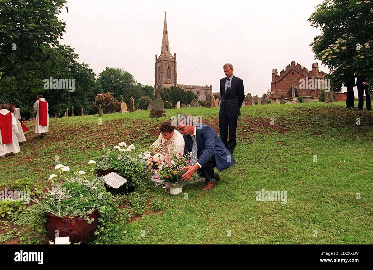 Bernard e Martine Figard posano i fiori oggi (lunedì) in un giardino commemorativo nella chiesa di St. Andrews, Ombersley, dedicato alla loro figlia, assassinato studente francese Celine Figard. Vedi la storia della Pennsylvania MEMORIAL Celine. IMMAGINE DAVID JONES/PA Foto Stock