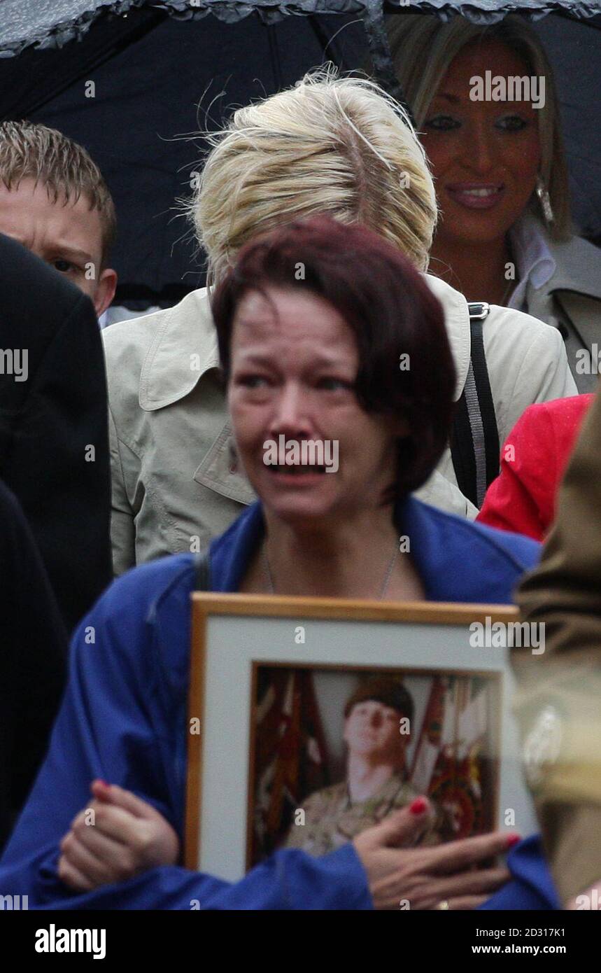 Lisa Billing porta dietro la sua bara una fotografia di suo figlio, il privato Daniel Wade, quando arriva per i suoi funerali alla chiesa di St Elphin, Warrington. Foto Stock