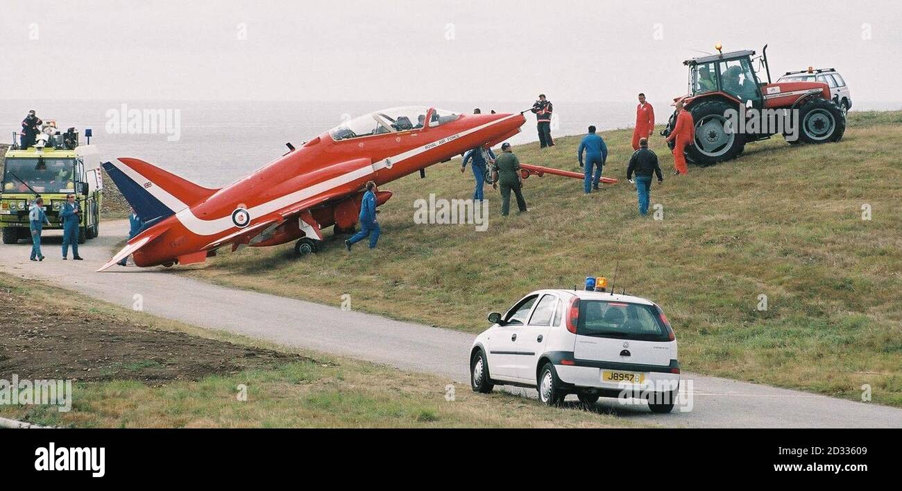 La barra di traino si scollega quando i tecnici aerei utilizzano un trattore per recuperare un aereo RAF Red Arrows che ha superato l'estremità occidentale della pista all'aeroporto di Jersey. Nessuno dei due membri dell'equipaggio di Hawk, con base a RAF Scampton nel Lincolnshire, che stava arrivando a Jersey per intraprendere esposizioni nella zona più tardi questa settimana, è stato ferito. Foto Stock