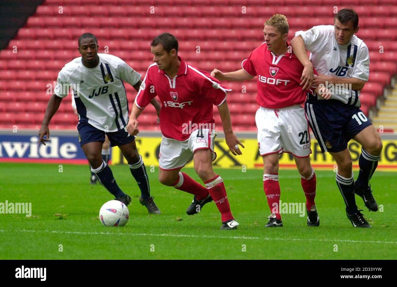 La strega di Mitch di Barnsley (seconda a sinistra) mantiene il possesso mentre il compagno di squadra David Mulligan tiene fuori una sfida da Lee McCulloch di Wigan (all'estrema destra). Guardando sopra (all'estrema sinistra) c'è Nathan Ellington di Wigan, durante la loro partita di Nationwide Division Two al Barnsley's Oakwell Ground. QUESTA IMMAGINE PUÒ ESSERE UTILIZZATA SOLO NEL CONTESTO DI UNA FUNZIONE EDITORIALE. NESSUN UTILIZZO NON UFFICIALE DEL SITO WEB DEL CLUB. Foto Stock