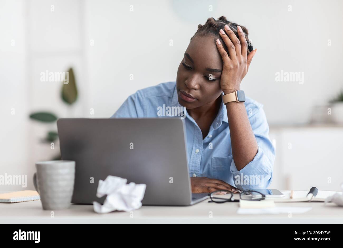 Crisi della creatività. Stressata donna freelance nera che guarda lo schermo del laptop con disperazione Foto Stock