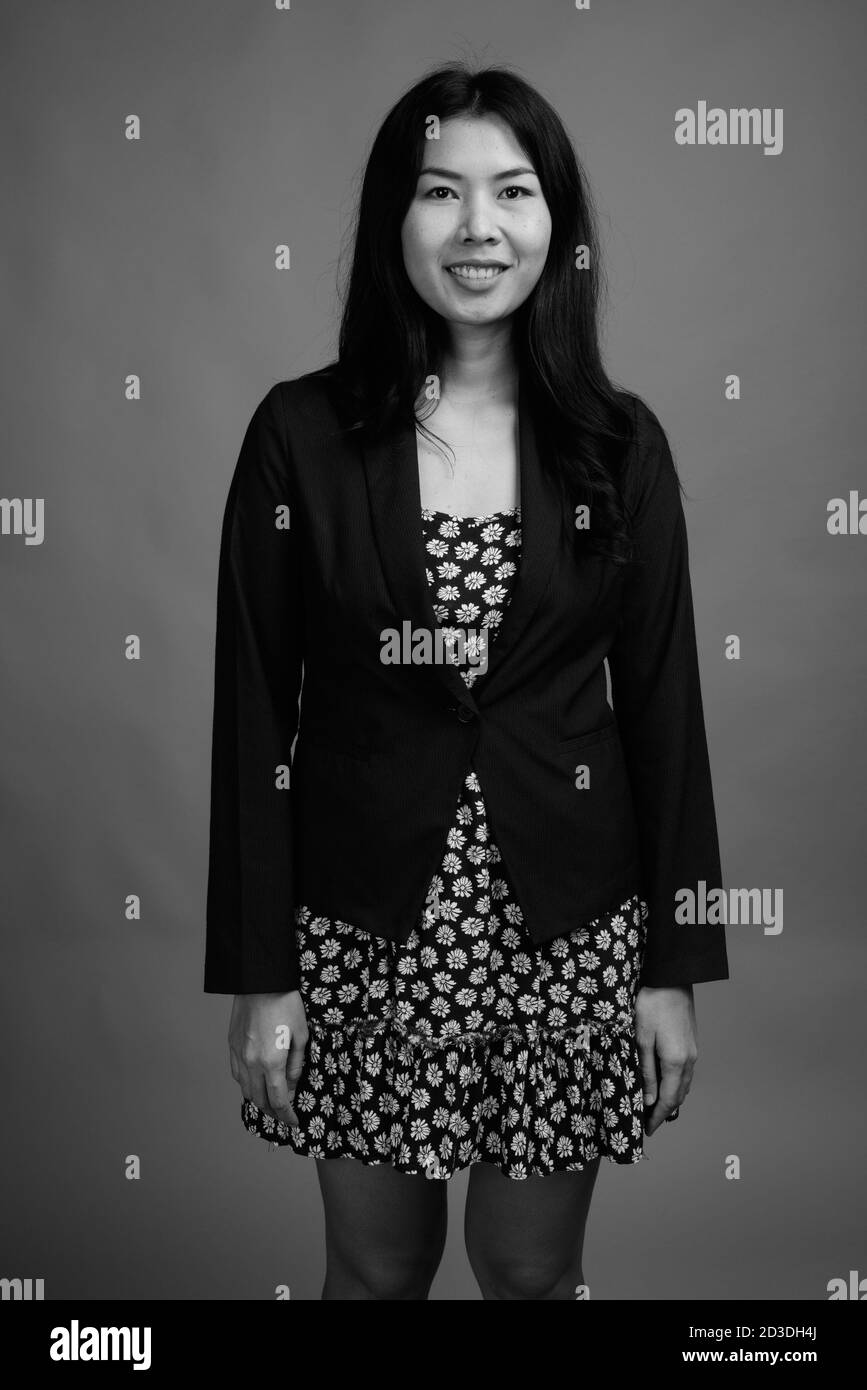 Ritratto di donna asiatica felice che indossa abito e maglione cardigan Foto Stock