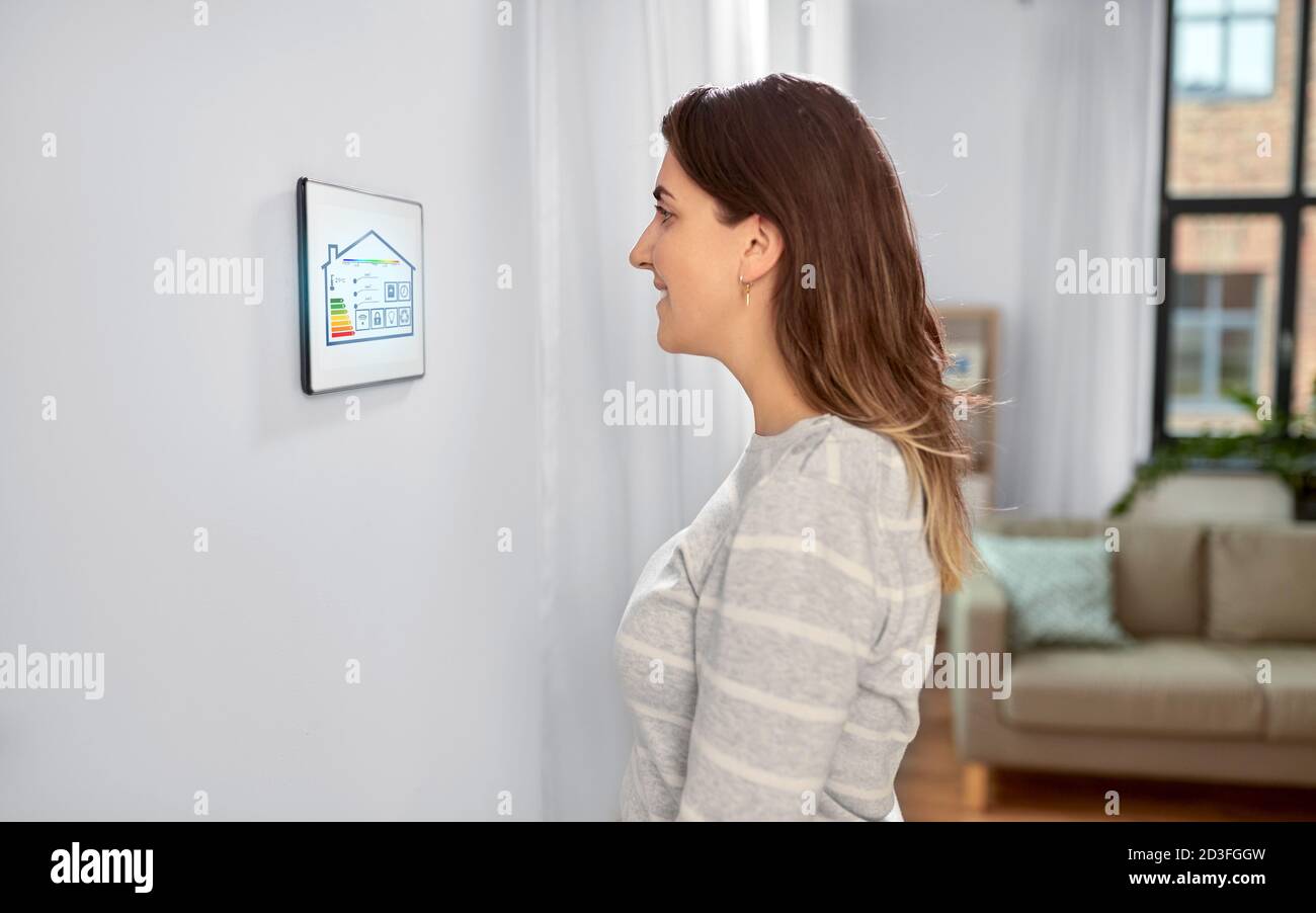 donna che guarda il tablet in una casa intelligente Foto Stock