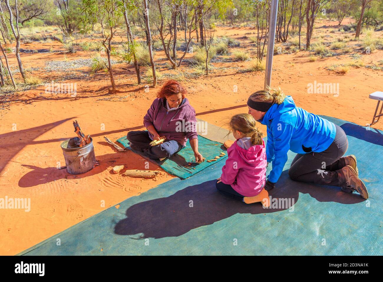 Stazione di Kings Creek, Territorio del Nord, Australia - 21 AGO 2019: famiglie con bambini osservare varietà boccola colorata semi raccolti a Karrke Foto Stock