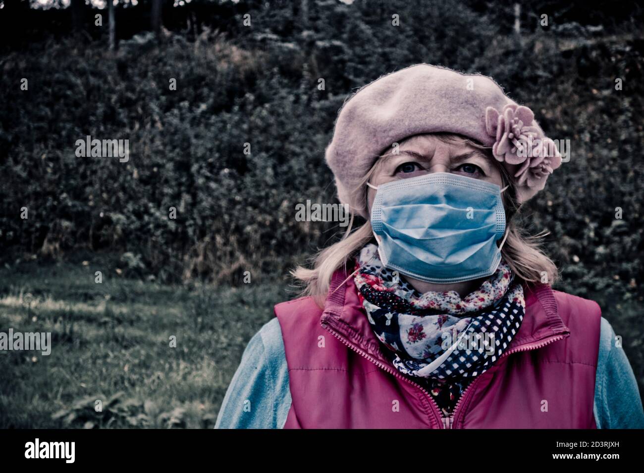 donna che indossa una maschera protettiva monouso contro il virus covid-19 Foto Stock