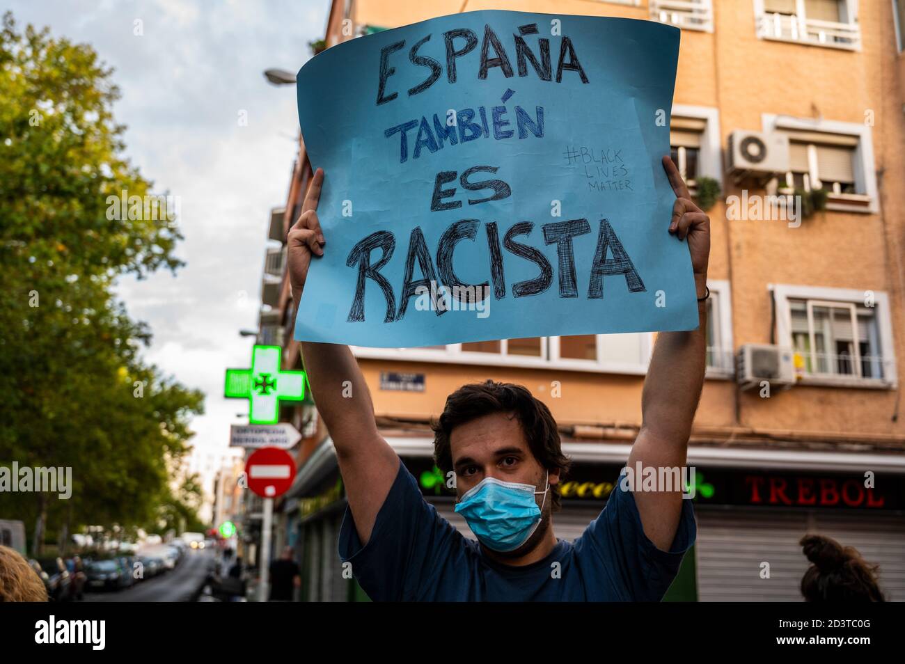 Madrid, Spagna. 8 ottobre 2020. Un uomo che protestava con un cartello che recita "anche il dolore è razzista", mentre i vicini di Vallecas si sono riuniti di fronte a un centro sanitario di primaria importanza per mostrare sostegno al sistema sanitario pubblico e per protestare chiedendo le dimissioni del presidente regionale Isabel Diaz Ayuso per la gestione negligente del coronavirus crisi. La Corte Suprema di Madrid ha annullato oggi le restrizioni di mobilità nella Comunità di Madrid imposte dal governo spagnolo e le zone più colpite dal COVID-19, 45 zone di Madrid (tra cui Vallecas), sono ritornate in un blocco awaitin Foto Stock