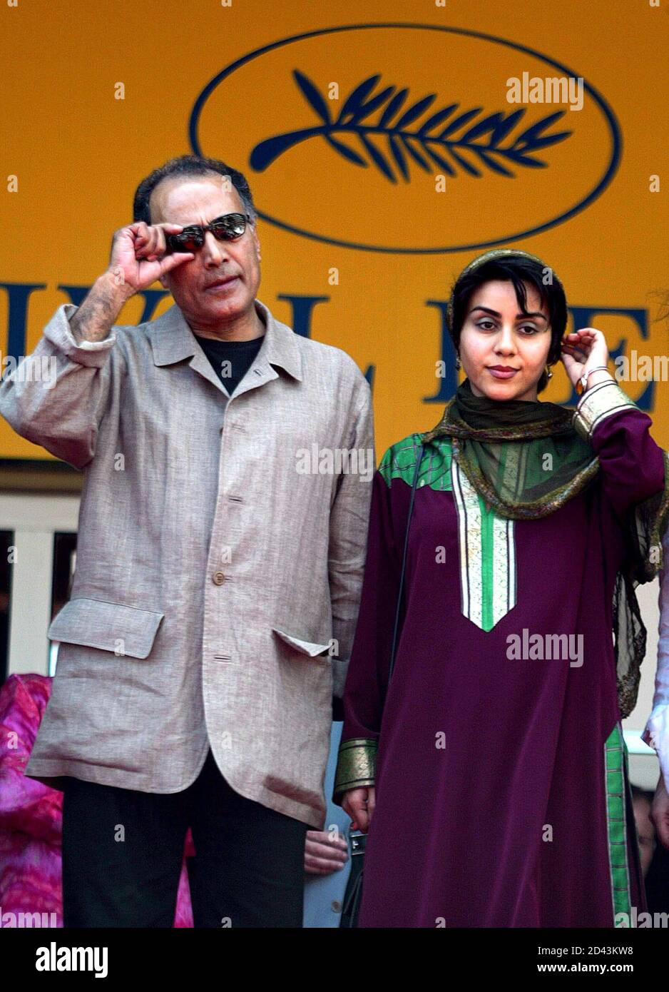 Iranian director Abbas Kiarostami (L) poses with Iranian actress Maria  Akbari (R) prior the screening of their film "Ten" in competition at the  55th Cannes film festival May 20, 2002. Twenty two