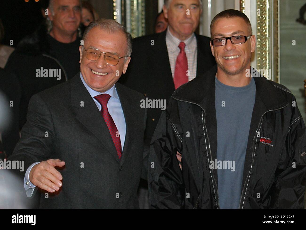 Romanian President Ion Iliescu (L) gestures near Belgian actor Jean-Claude Van  Damme (R) as they enter the Cotroceni presidential palace in Bucharest,  November 30, 2004. Romania is attracting an increasing number of
