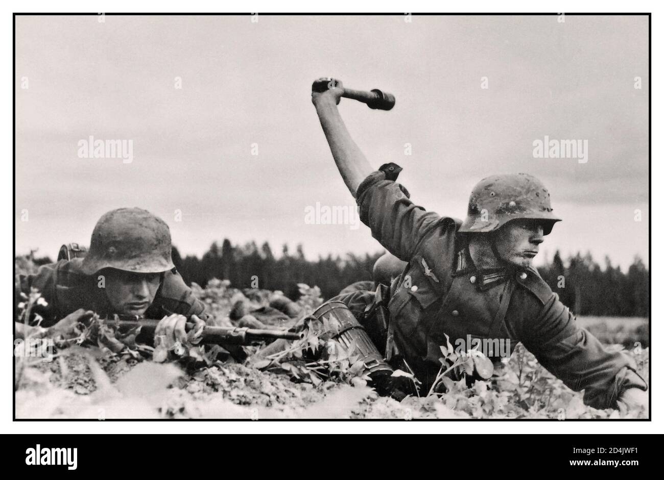 Truppe tedesche della seconda guerra mondiale in Russia, 1941 adagiate sul pavimento, un soldato dell'esercito tedesco Wehrmacht lancia una granata a bastone. Combattimenti sul fronte Orientale seconda guerra mondiale Foto Stock