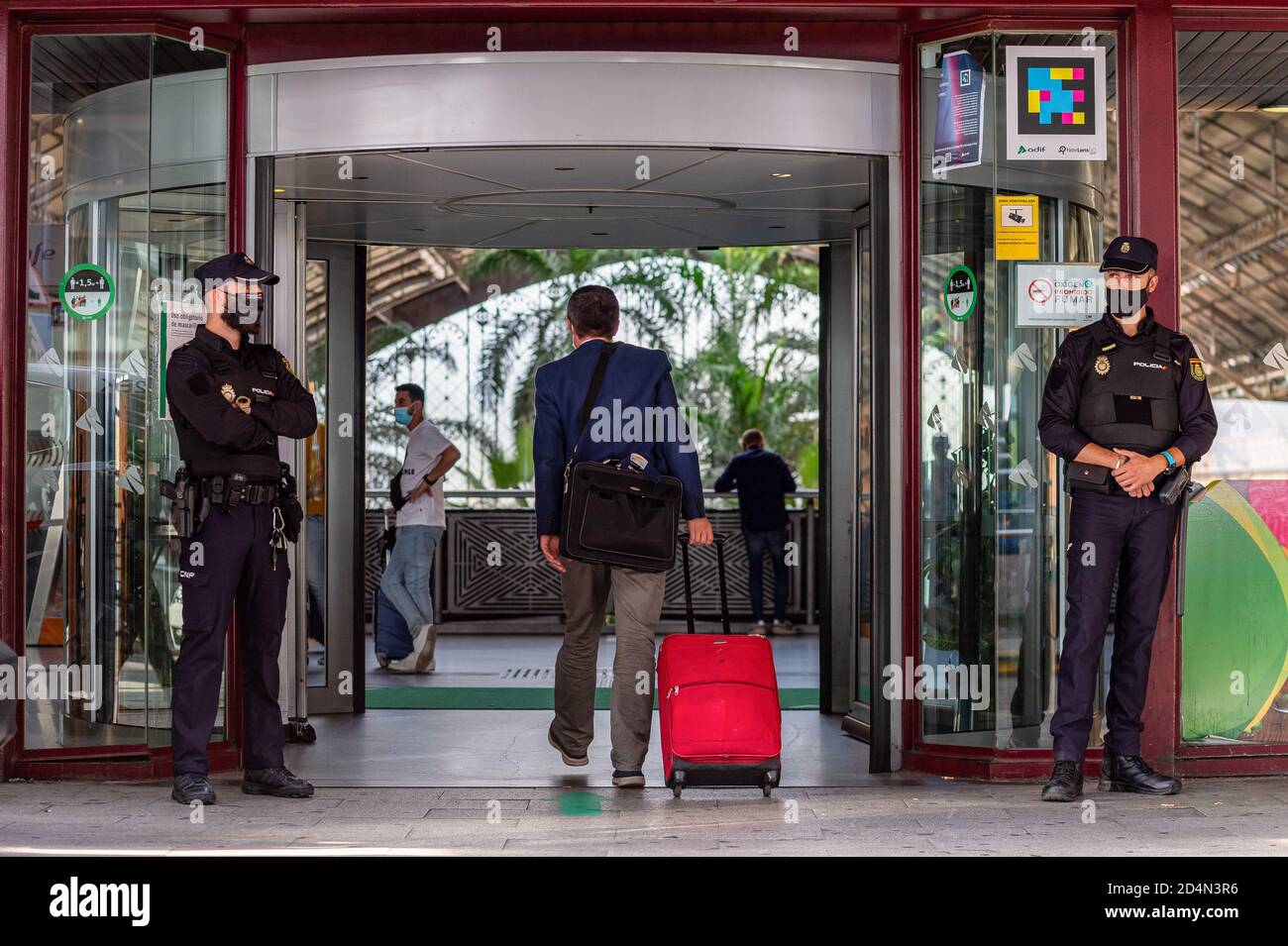 Madrid, Spagna. 1 gennaio 2012. La polizia si trova in guardia alla porta della stazione ferroviaria di Atocha durante lo stato di allarme. Il governo spagnolo ha dichiarato uno stato di allarme per 15 giorni nella Comunità di Madrid a causa dell'elevato numero di infezioni da Covid 19 durante la seconda ondata della pandemia in Spagna. Credit: Diego Radames/SOPA Images/ZUMA Wire/Alamy Live News Foto Stock