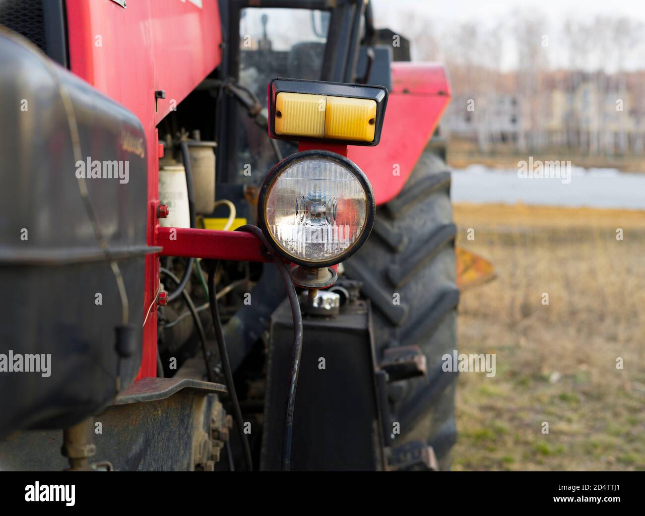 Vista ravvicinata della parte anteriore di un grande trattore rosso, del trattore per lavori in agricoltura di grandi dimensioni o di costruzione di strade e altri lavori Foto Stock