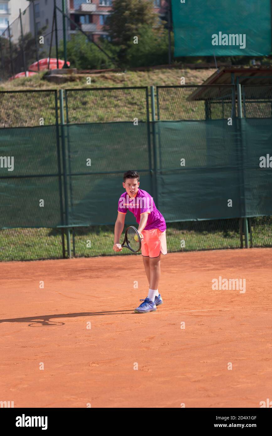 Giovane tennista che serve la palla Foto Stock