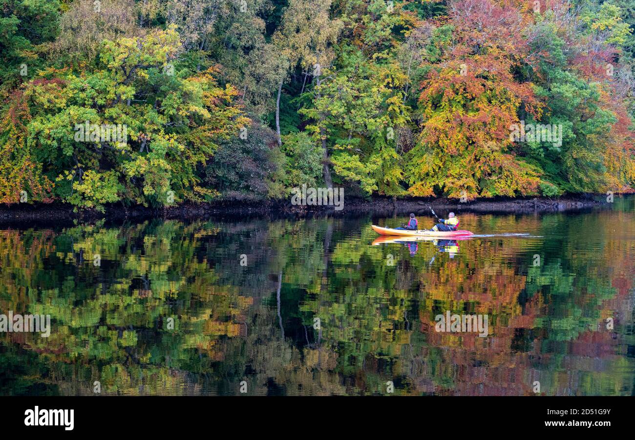 Pitlochry, Scozia, Regno Unito. 12 ottobre 2020. Colori autunnali su alberi e membro del pubblico in kayak sul Loch Faskally a Pitlochry. Iain Masterton/Alamy Live News Foto Stock