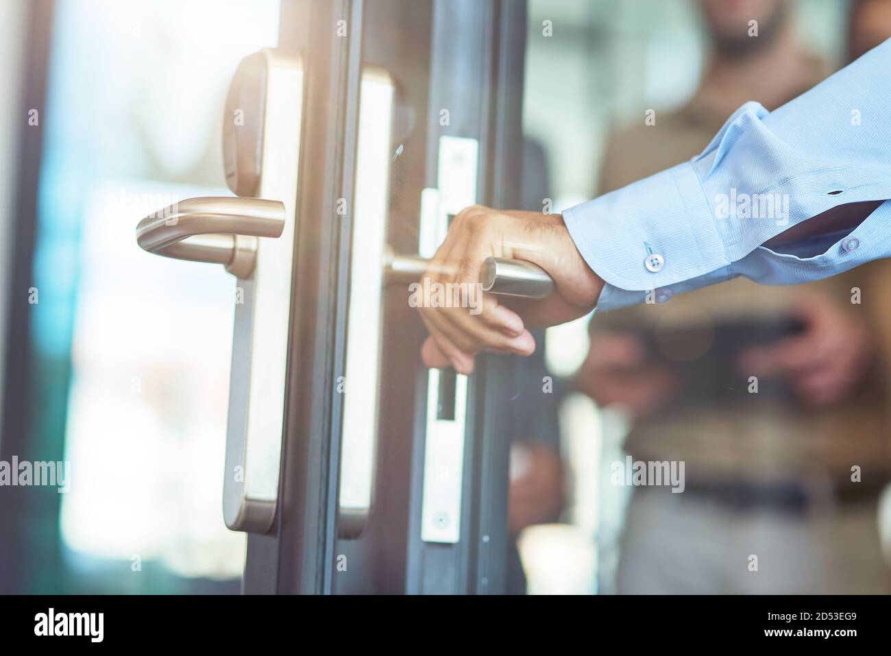 Porta di vetro con apertura a mano maschile nell'ufficio moderno, primo piano Foto Stock