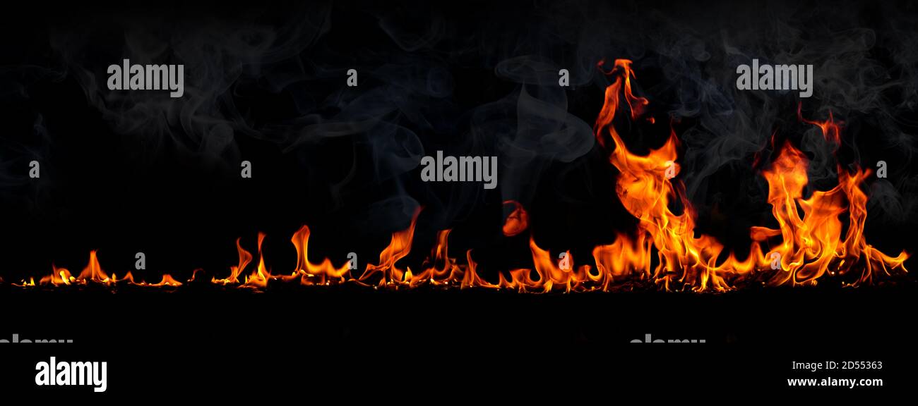 Fiamme di fuoco con fumo su sfondo nero, rosso bruciante scintille calde, arancione fuoco incandescente particelle volanti Foto Stock