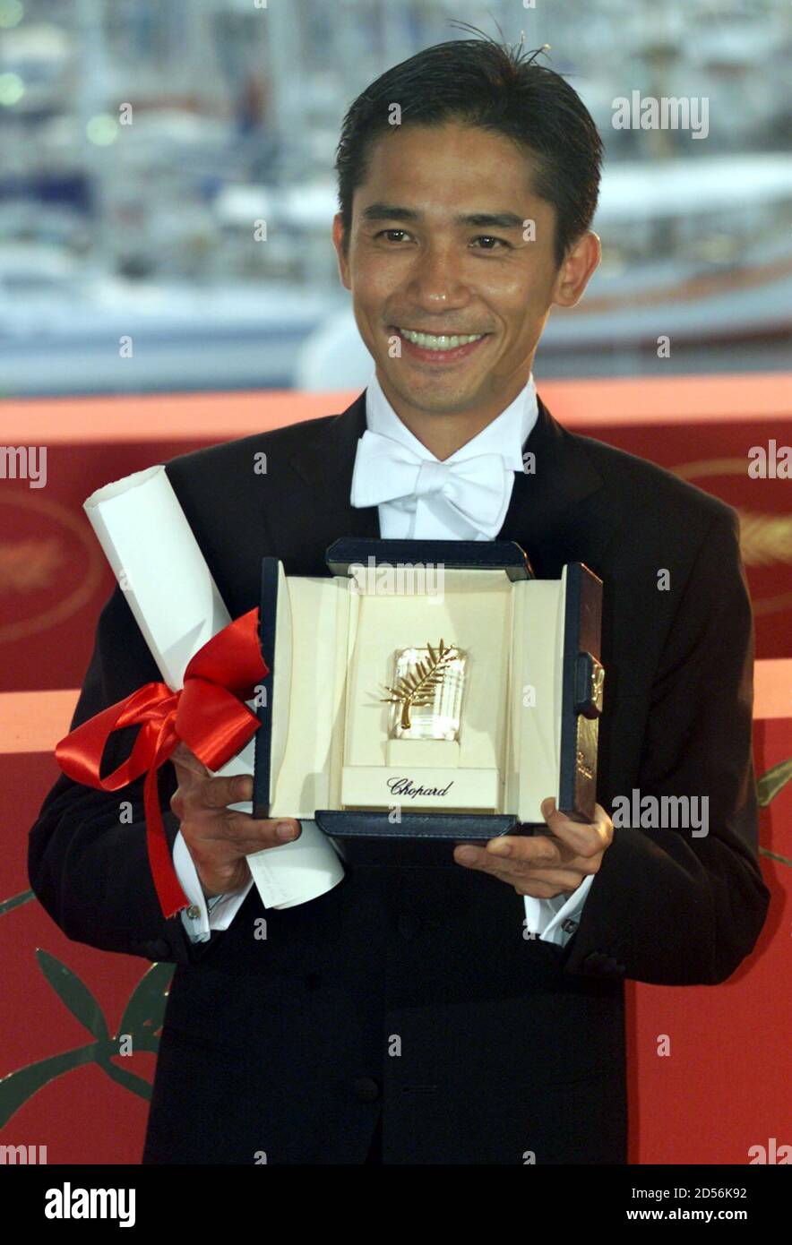 Best Actor award winner Chinese actor Tony Leung Chiu-Wai holds his award  for his role in Chinese [director Wong Kar-wai's] 'In the Mood for Love'  during a photo call after the closing