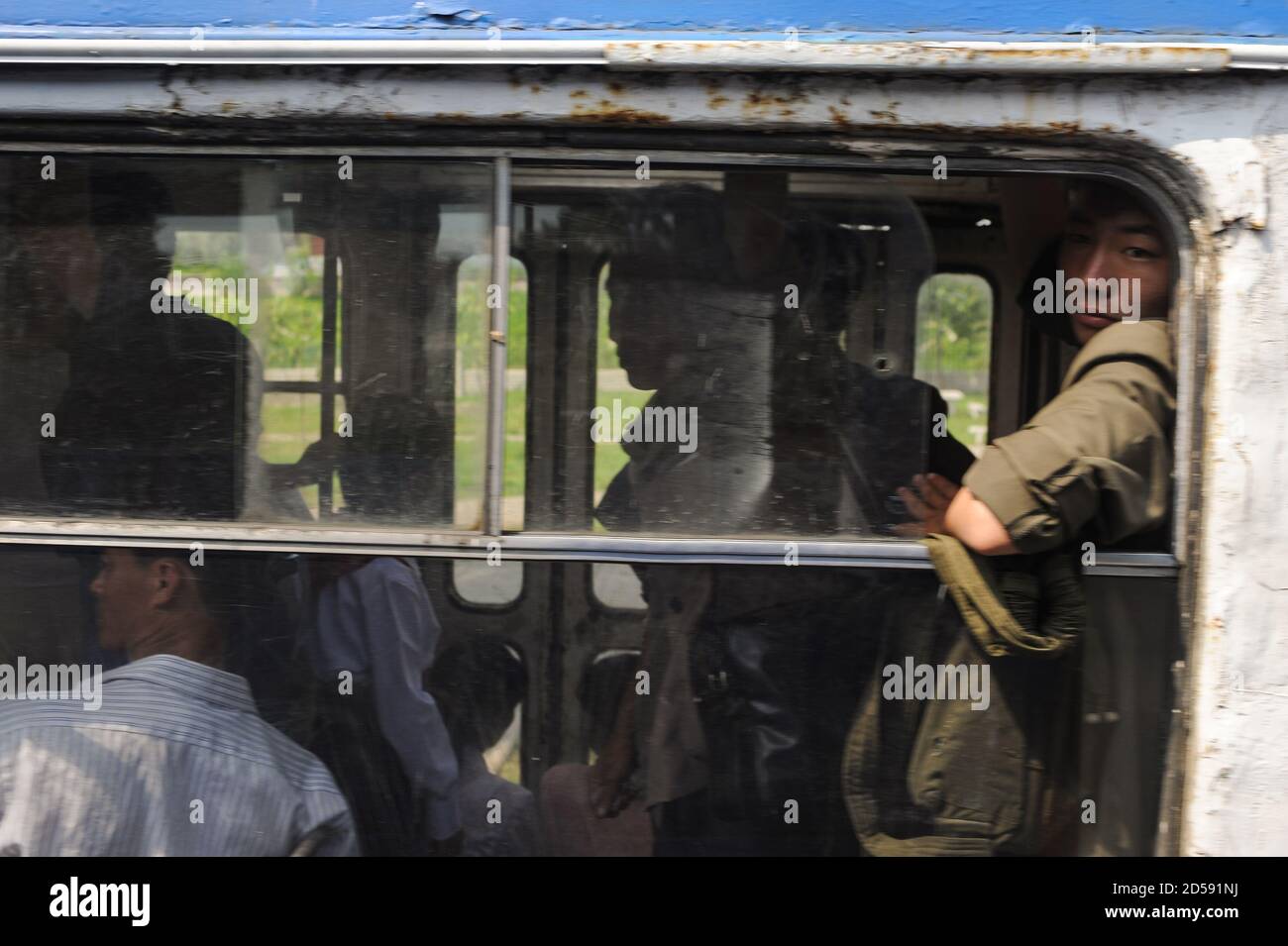 08.08.2012, Pyongyang, Corea del Nord, Asia - i pendolari guardano fuori dalla finestra aperta di un tram completamente occupato nel centro della capitale della Corea del Nord. Foto Stock